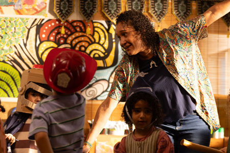 Danielle, a teacher, dancing with children at kindy