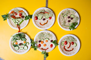 Plates of food arranged to look like smiling faces